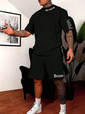 Men's blue printed short-sleeve top and matching shorts sports suit on a hanger.