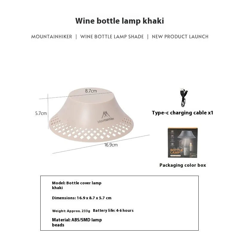 Beige and grey wine bottle shaped camping lantern with USB-C port on a wooden table.