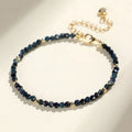 Close-up of a 3mm blue tourmaline cut bead spacer bracelet on a wrist.