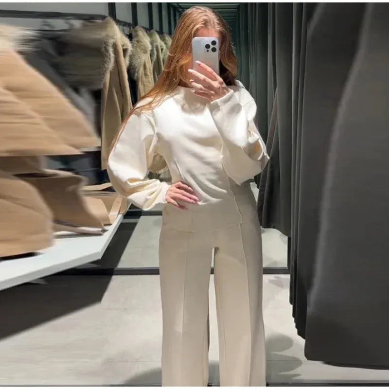 Women's black polyester fleece long sleeve top and wide leg pants two-piece suit set with pockets.