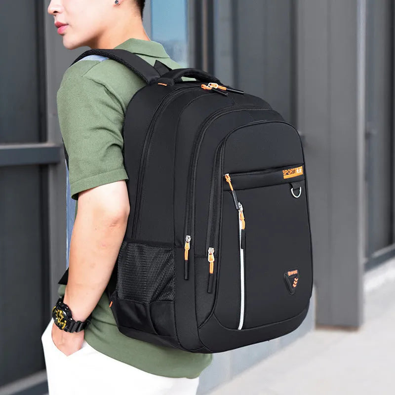 Men's Oxford cloth schoolbag with letter pattern in black, blue, green, or red colours showing air pillow belt system