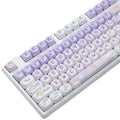 Close-up of purple gradient rabbit design on white PBT keycaps for mechanical keyboards.