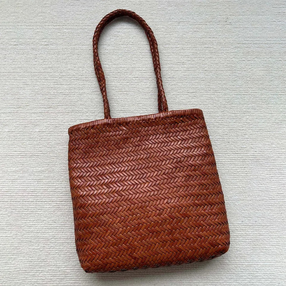 Brown woven leather tote bag with three-dimensional pockets and shoulder straps