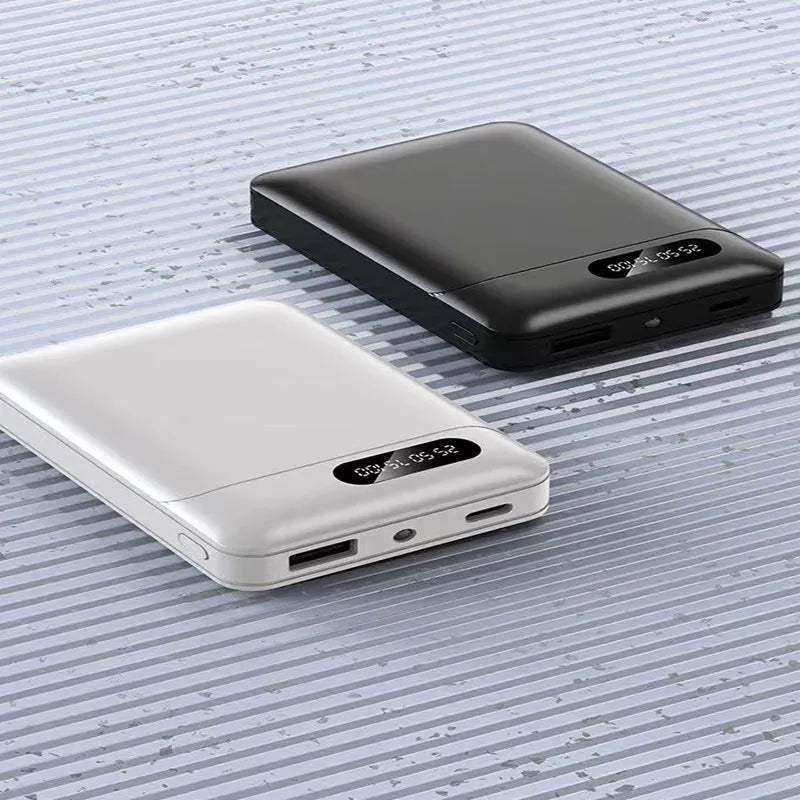 Black or white portable power bank with dual USB ports showing 10000mAh capacity