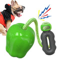 Green apple-shaped dog molar toy with dropping ball mechanism on white background