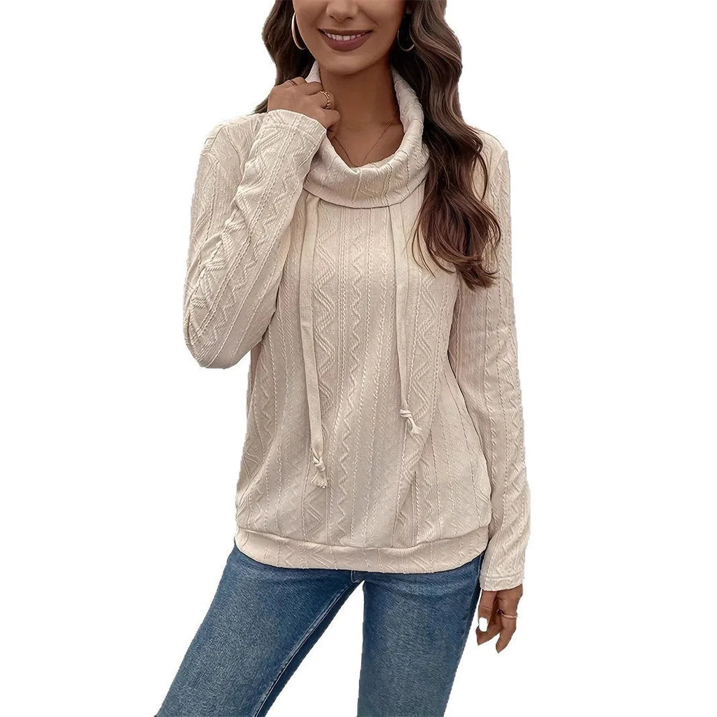 Apricot coloured women's hooded pullover sweater with long sleeves on a hanger.