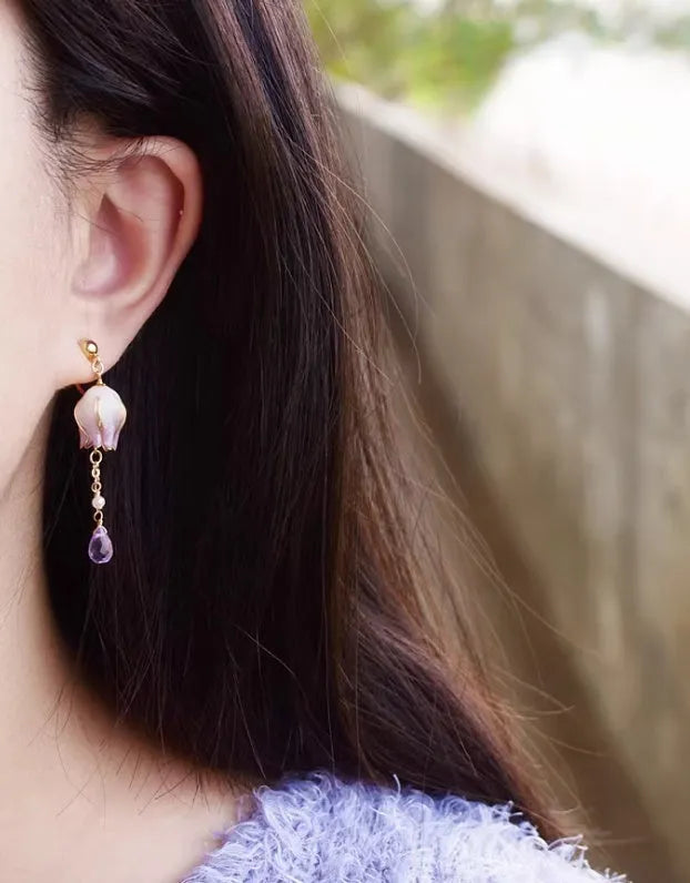 Silver plated gradient colour amethyst water drop tassel ear studs with flower core pattern on white background