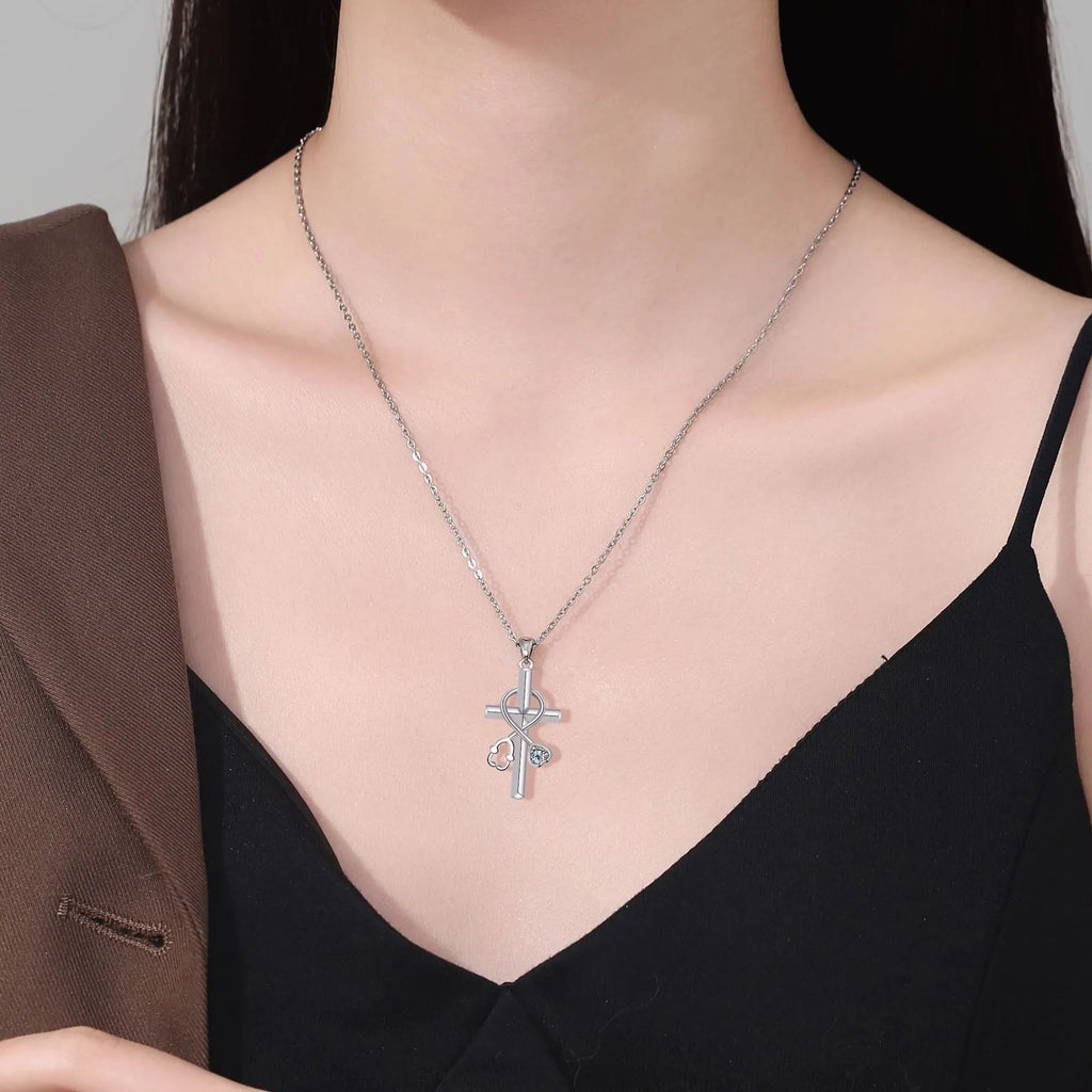 Silver-coloured women's necklace with a pendant shaped as a cross combined with a stethoscope.