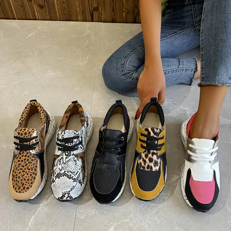 Women's suede flat sneakers with a wedge heel in leopard print, shown from the side.