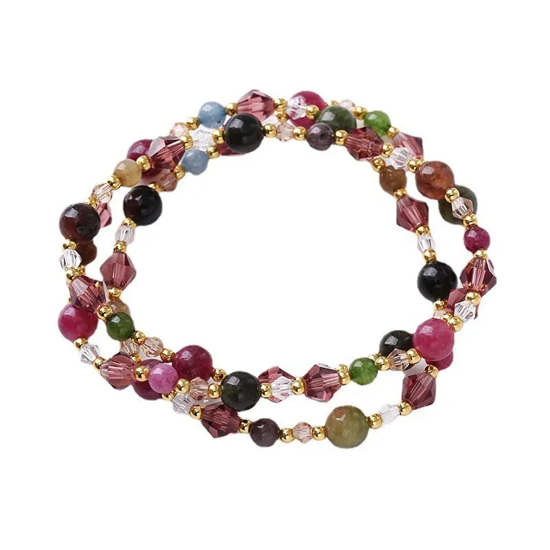 Handmade women's bracelet with tourmaline, strawberry quartz, and amethyst beads on adjustable rope