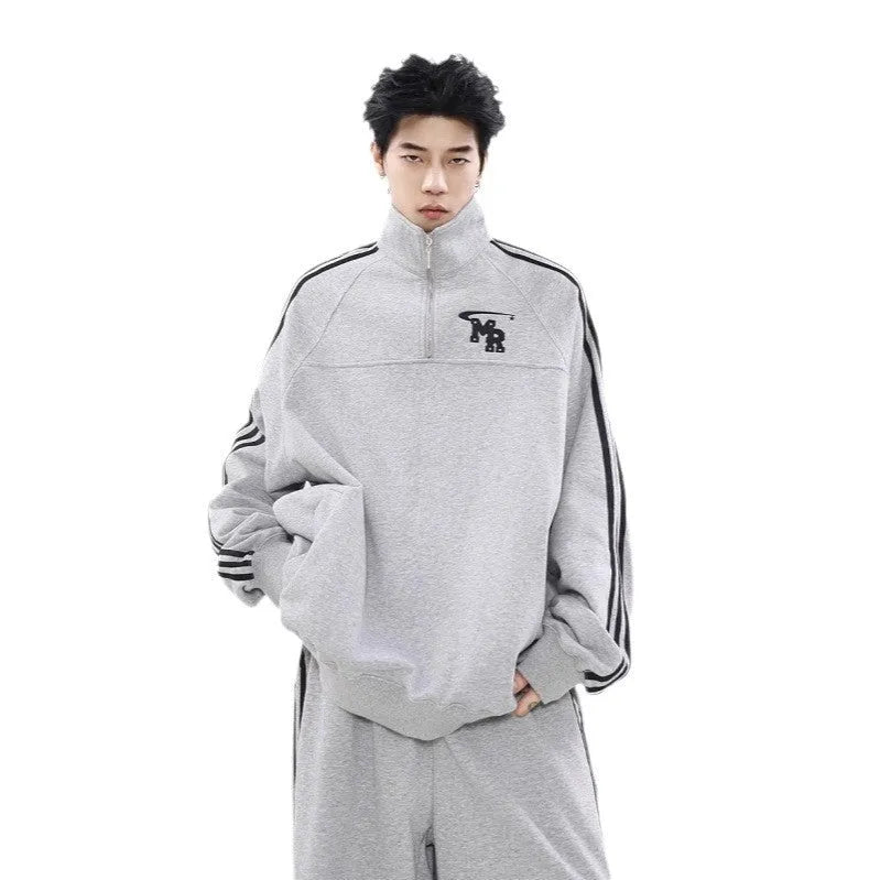 Black Hong Kong style stand collar long sleeve polyester sports hoodie on a hanger