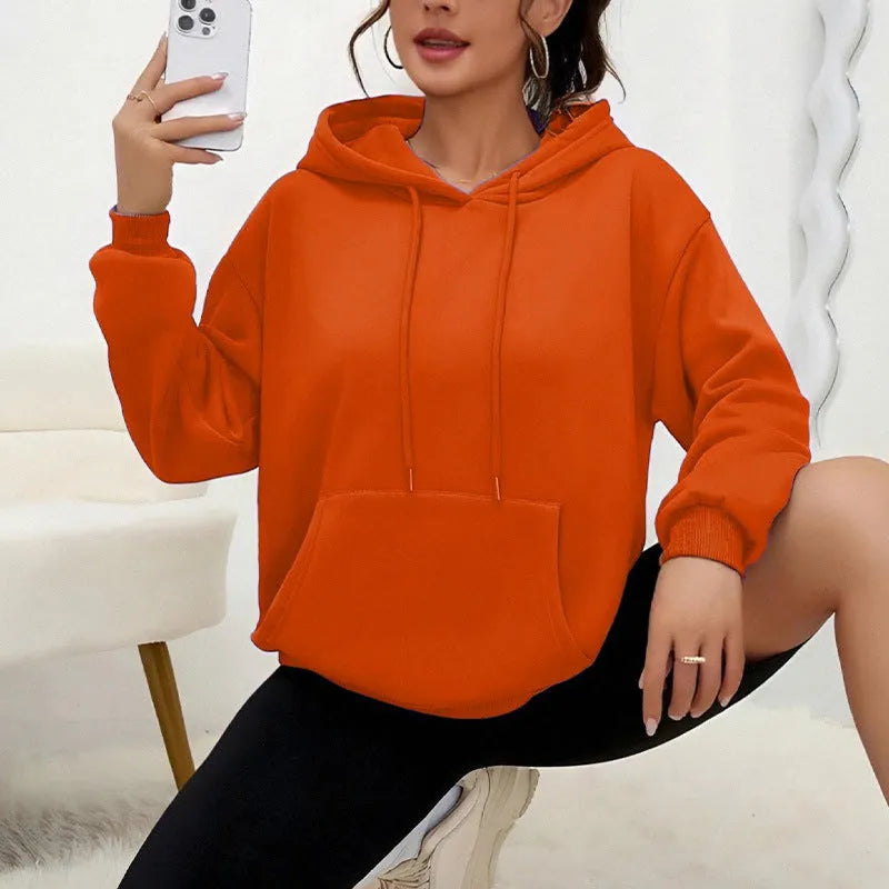 Women's loose grey drawstring pocket sweatshirt with long sleeves and a front pouch.