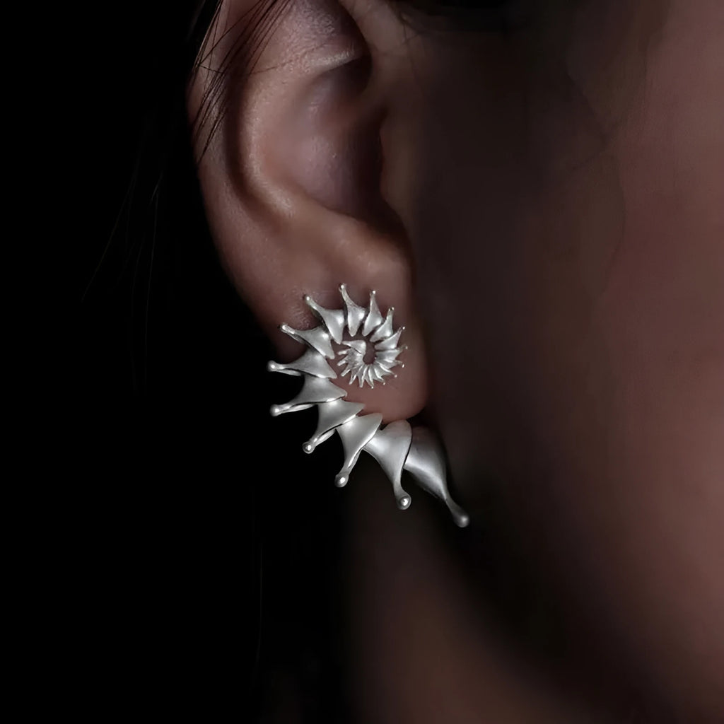Conch coloured stud earrings with three-dimensional irregular design and matte alloy finish