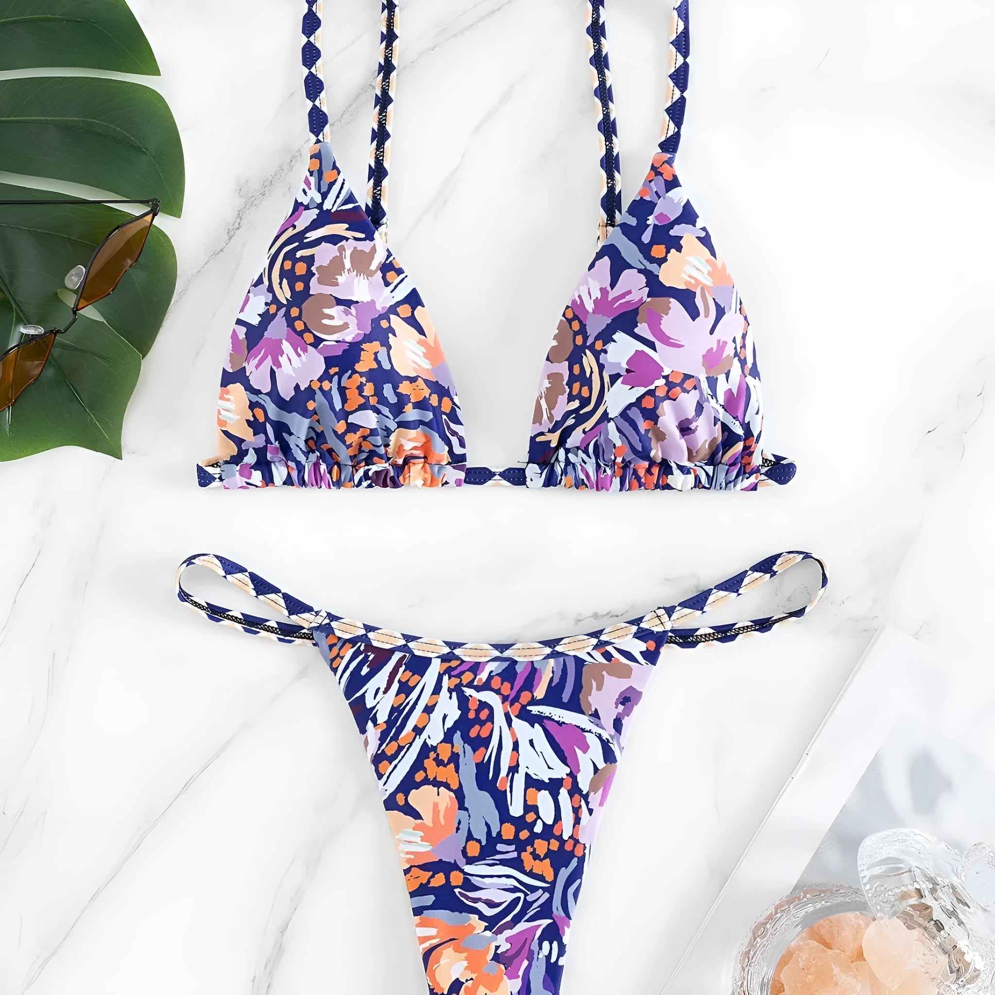 Women's floral print polyester triangle bikini swimsuit with briefs-style bottom.
