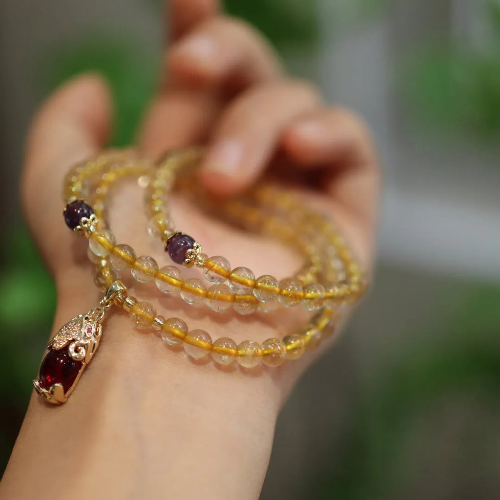 Natural Brazil gold rutilated quartz bracelet with three gold circles and ruby quartz charms in Chinese style