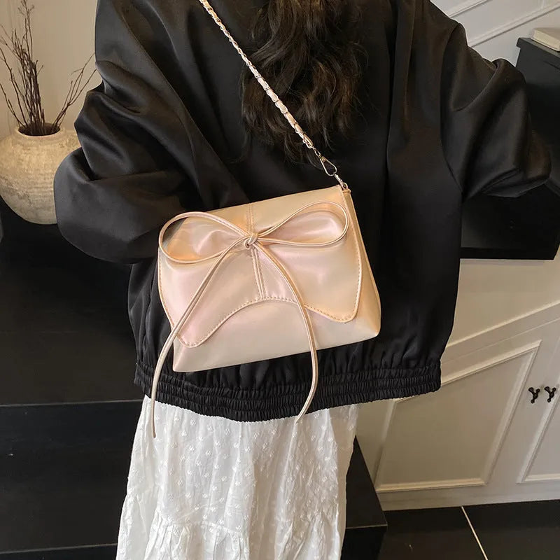 Women's black PU leather crossbody bag with large capacity and a front sandwich pocket.