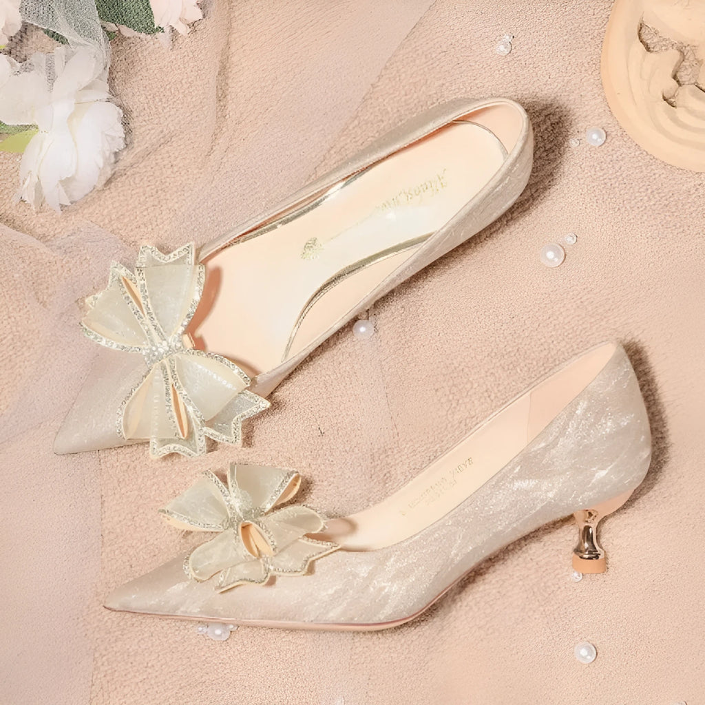 Women's champagne sequinned pointed toe stiletto high heels with a low cut, shown on a plain background.