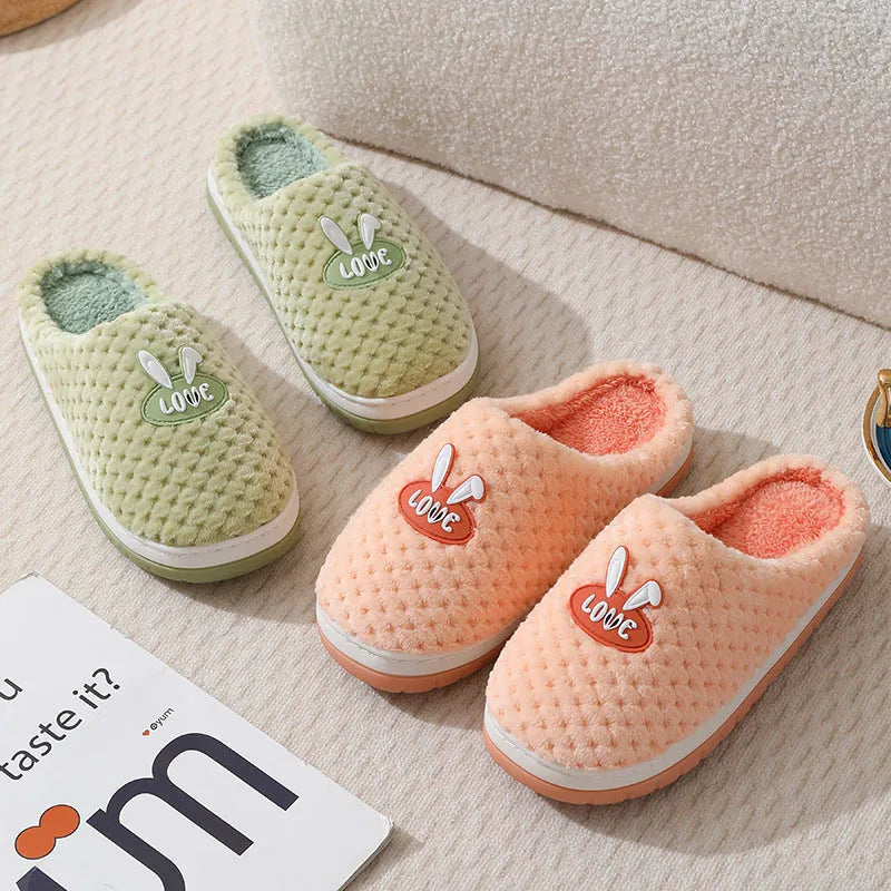 Women's rabbit and plaid print artificial fur slippers with thick rubber sole.