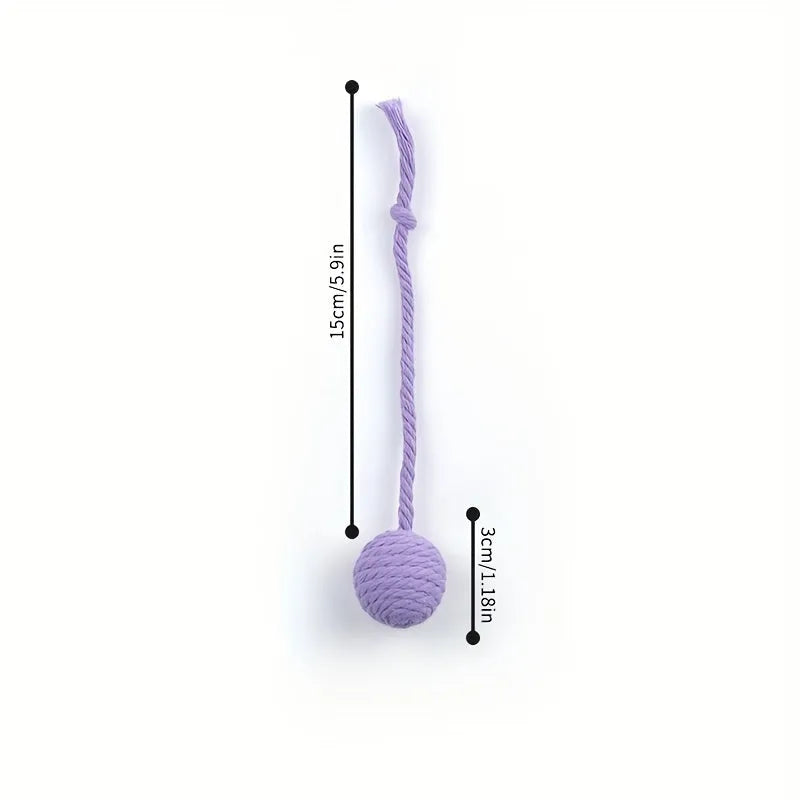 Green cat toy ball with attached rope and internal bell next to a pink one.