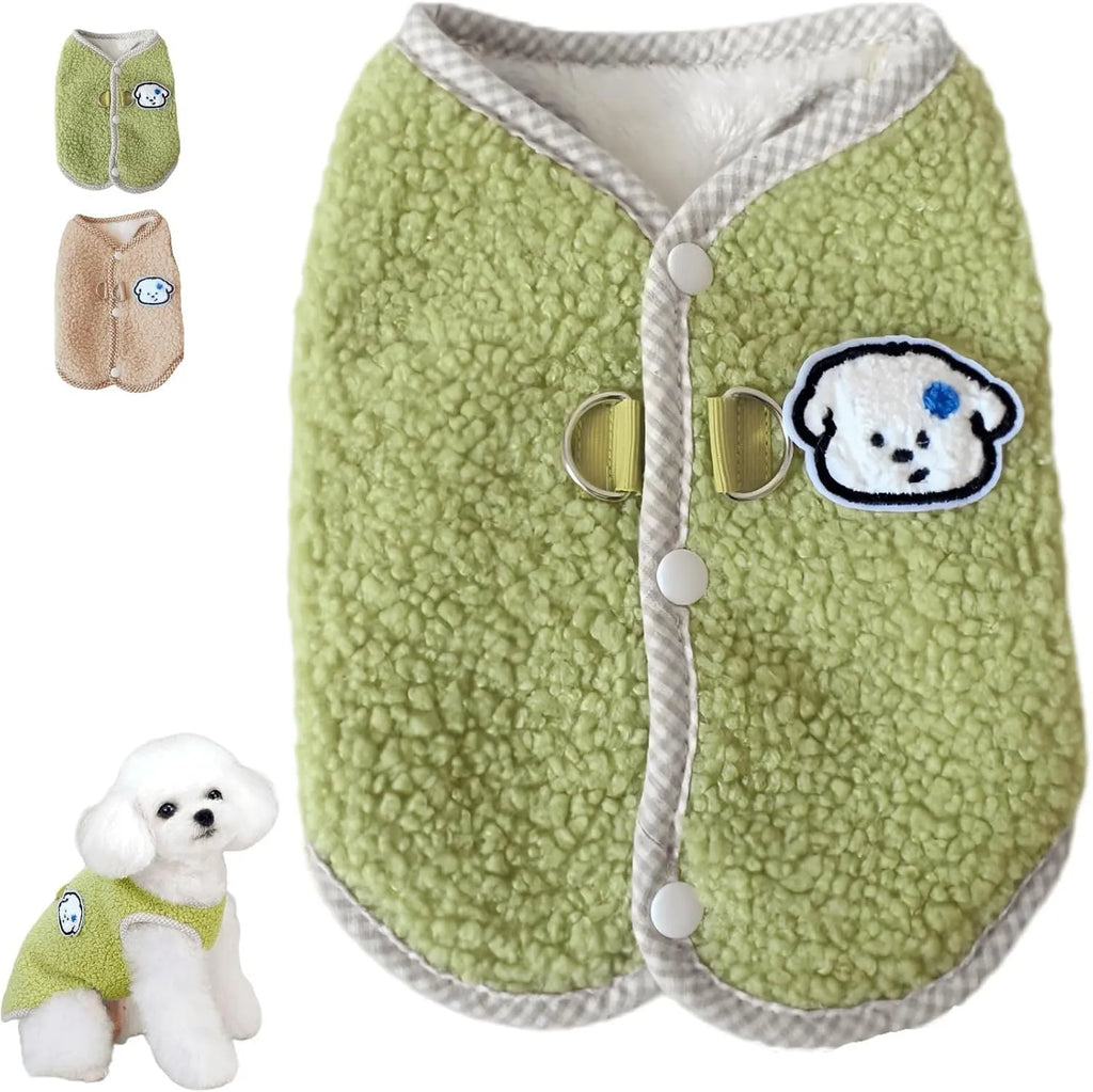 Green coral fleece dog vest with a metal leash ring on the back, fastened at the side on a small dog.