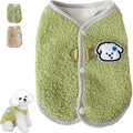 Green coral fleece dog vest with a metal leash ring on the back, fastened at the side on a small dog.