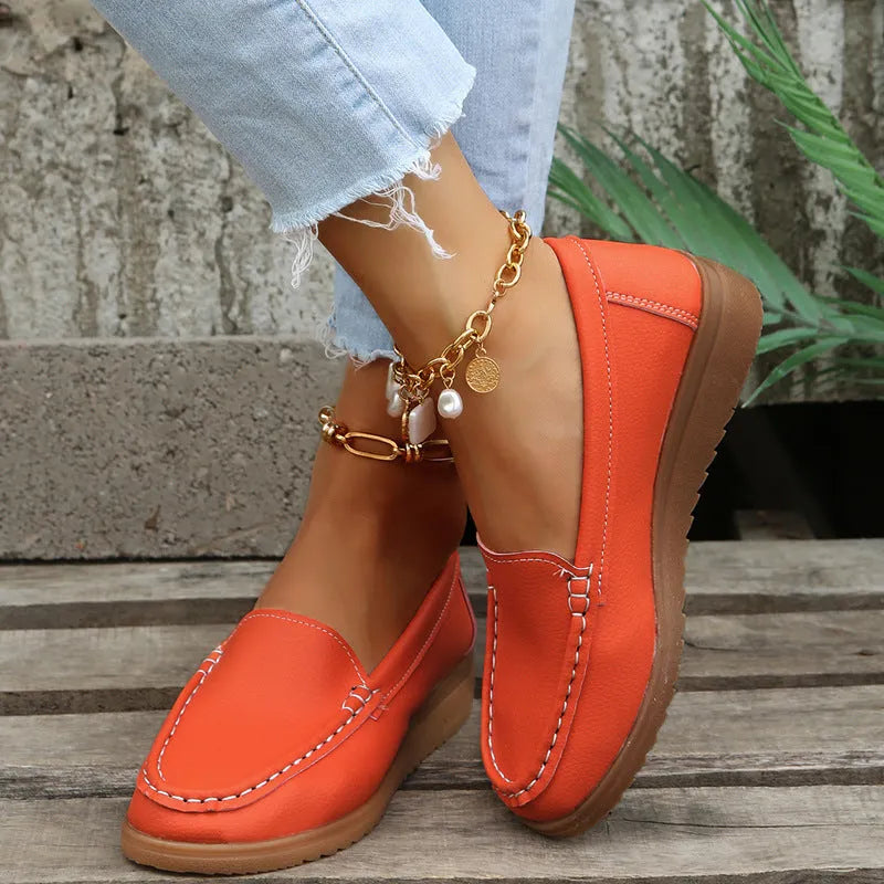 Women's flat loafer shoe in PU leather with a rubber sole, shown in a choice of colours.