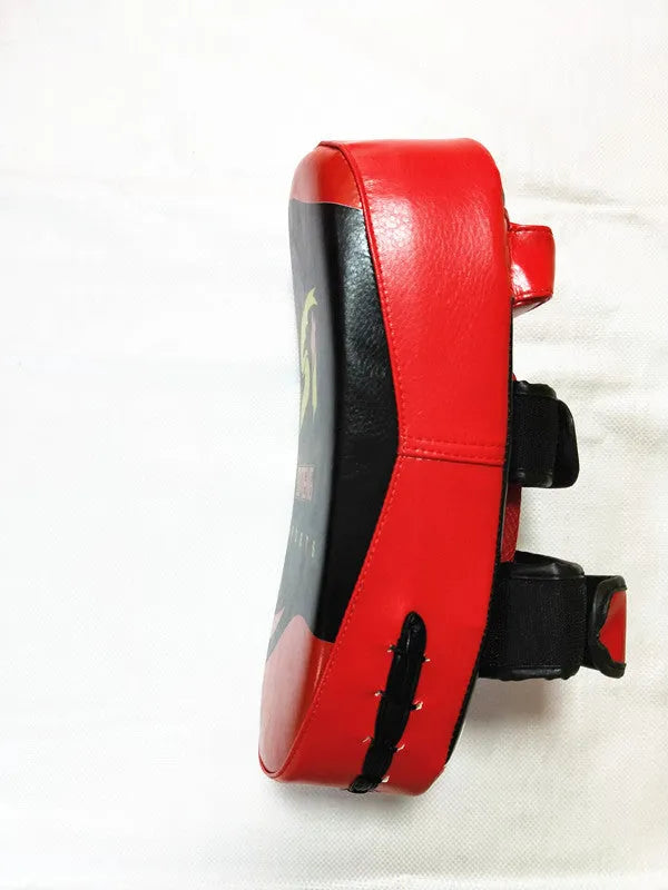Black square boxing training pad with red trim, showing back with double buckle straps.