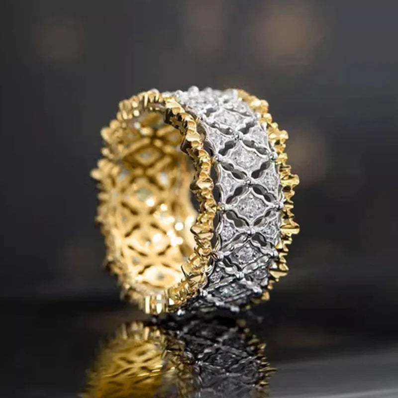 Geometric two-tone gold ring with a round zircon centre on a copper band.