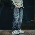 Men's blue loose straight retro style polyester denim trousers on a neutral background.