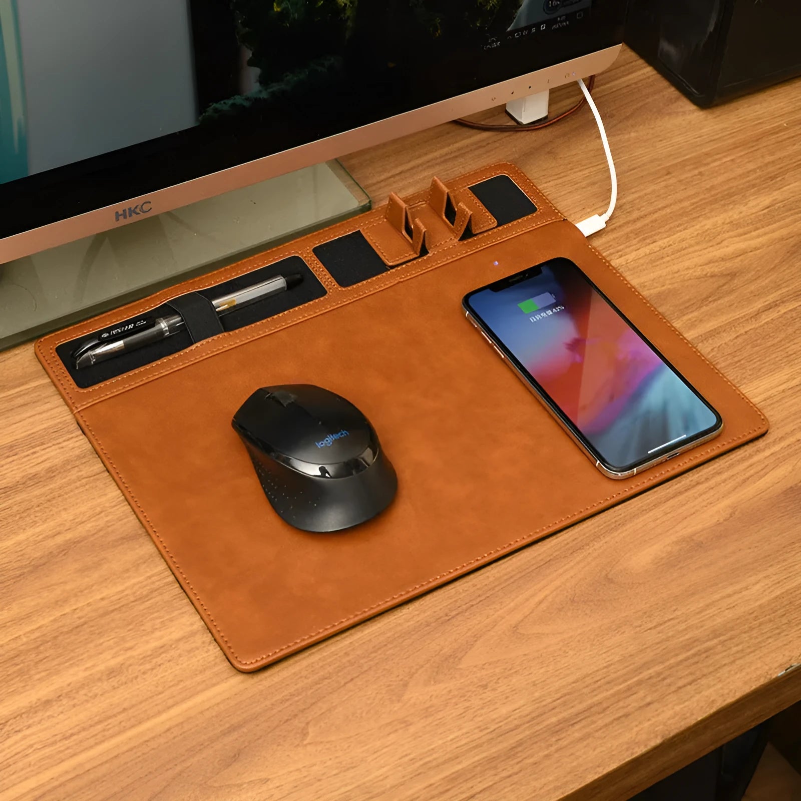 Pink wireless charging mouse pad with phone holder on a desk, showing USB cable and 320mm x 260mm size.