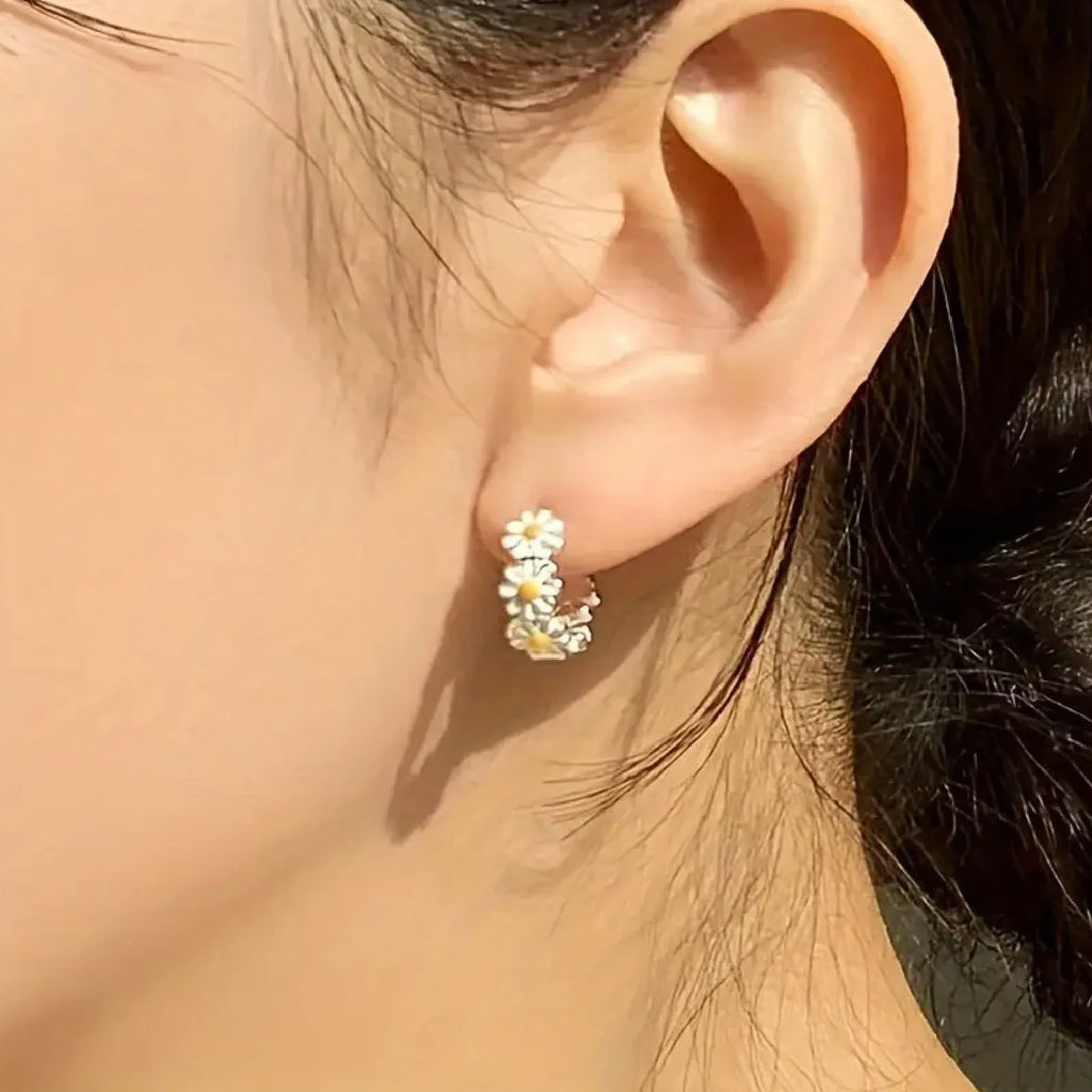 White daisy flower ring earrings with electroplated copper and platinum-accented gems.