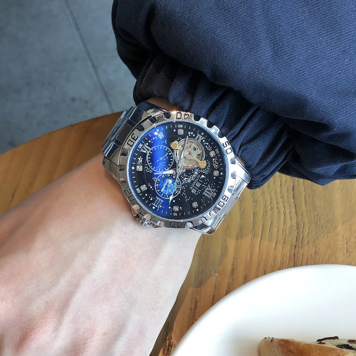 Men's silver automatic mechanical watch with black dial, luminous markers, and genuine leather strap