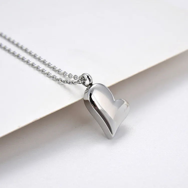 Silver curved peach heart stainless steel pendant necklace with adjustable chain length