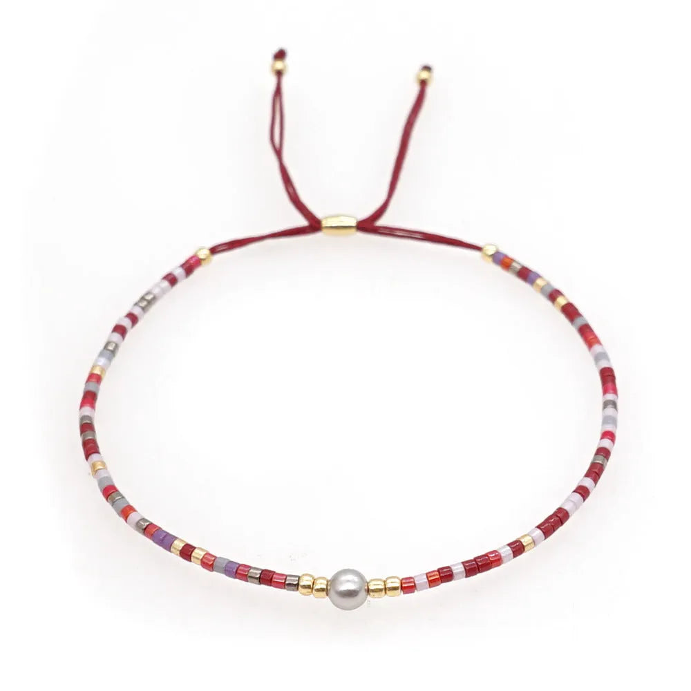 Handmade women's beaded bracelet with colourful glass and glaze beads in geometric bohemian style