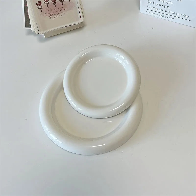 White porcelain plate with bear doodle design, shown as a plant pot tray.