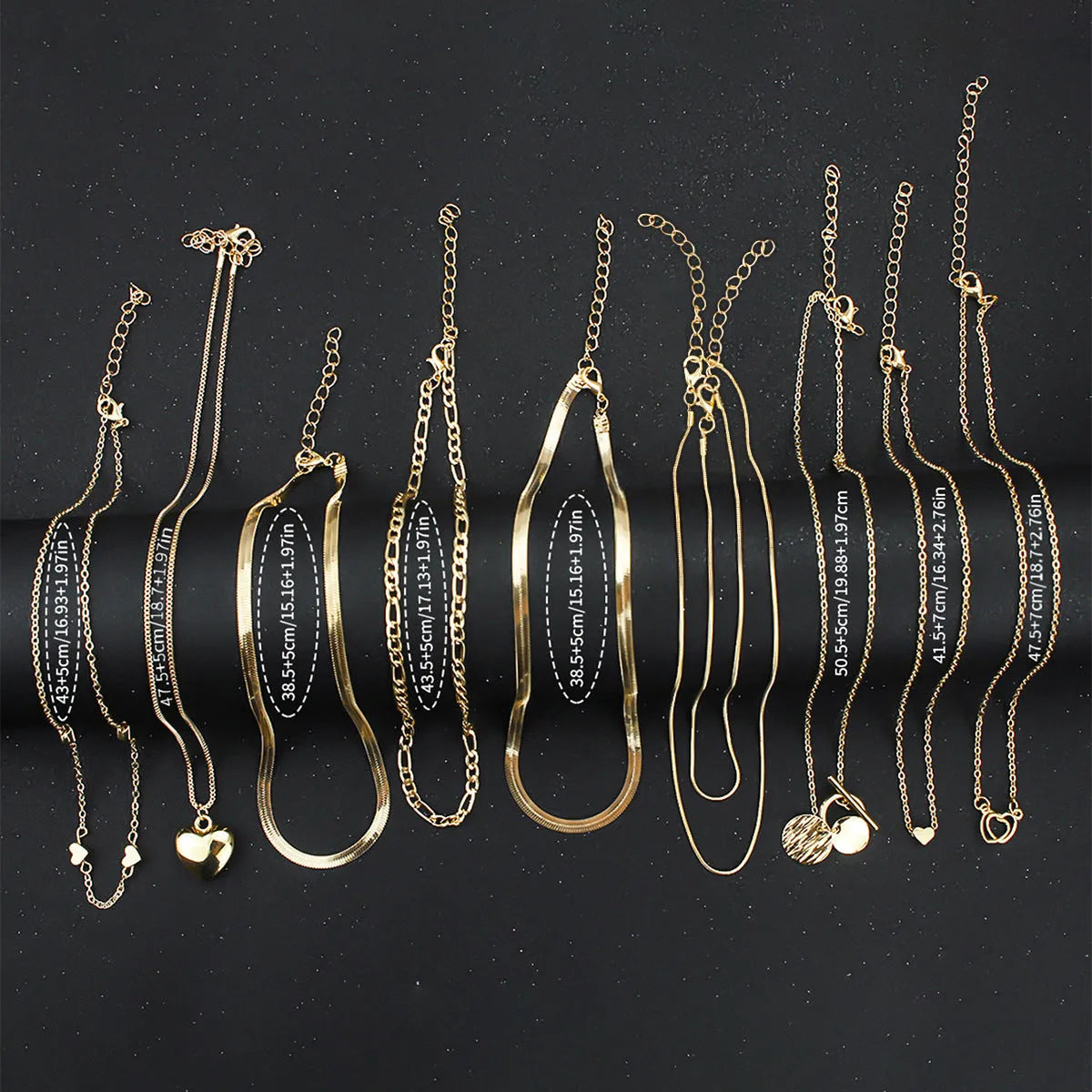 10 piece gold electroplated women's necklace set with adjustable chain length on display