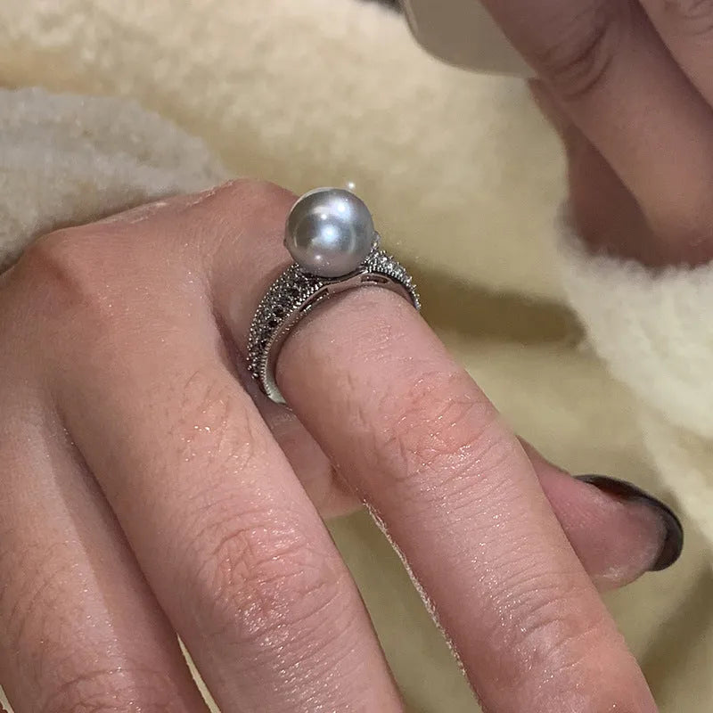 Geometric copper ring with black pearl and adjustable opening for women.