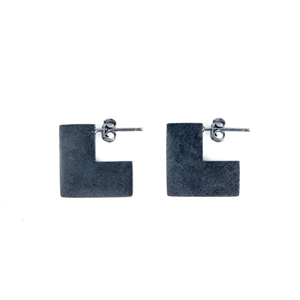 Square oxidised black sterling silver geometric earrings on a white background.