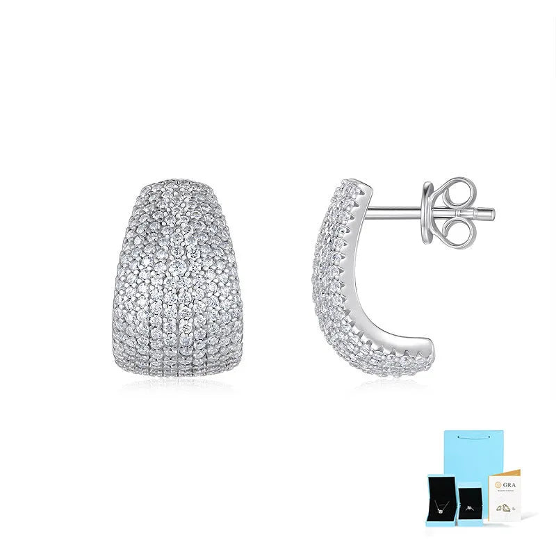 Geometric moissanite stud earrings with sterling silver posts on a gift box