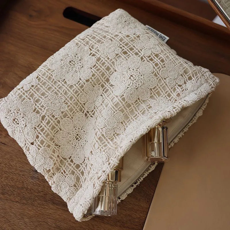 Handmade corduroy cosmetic bag with a crocheted hollow flower and ethnic embroidery design.