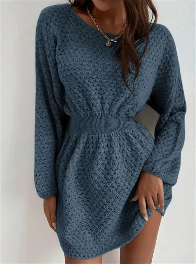 Blue women's knitted dress with hand-crocheted floral details on the front, showing fitted waist and round neck.