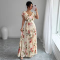 Apricot coloured floral print dress with a v-neck, ruffled short sleeves, and a long high-waisted swing skirt.