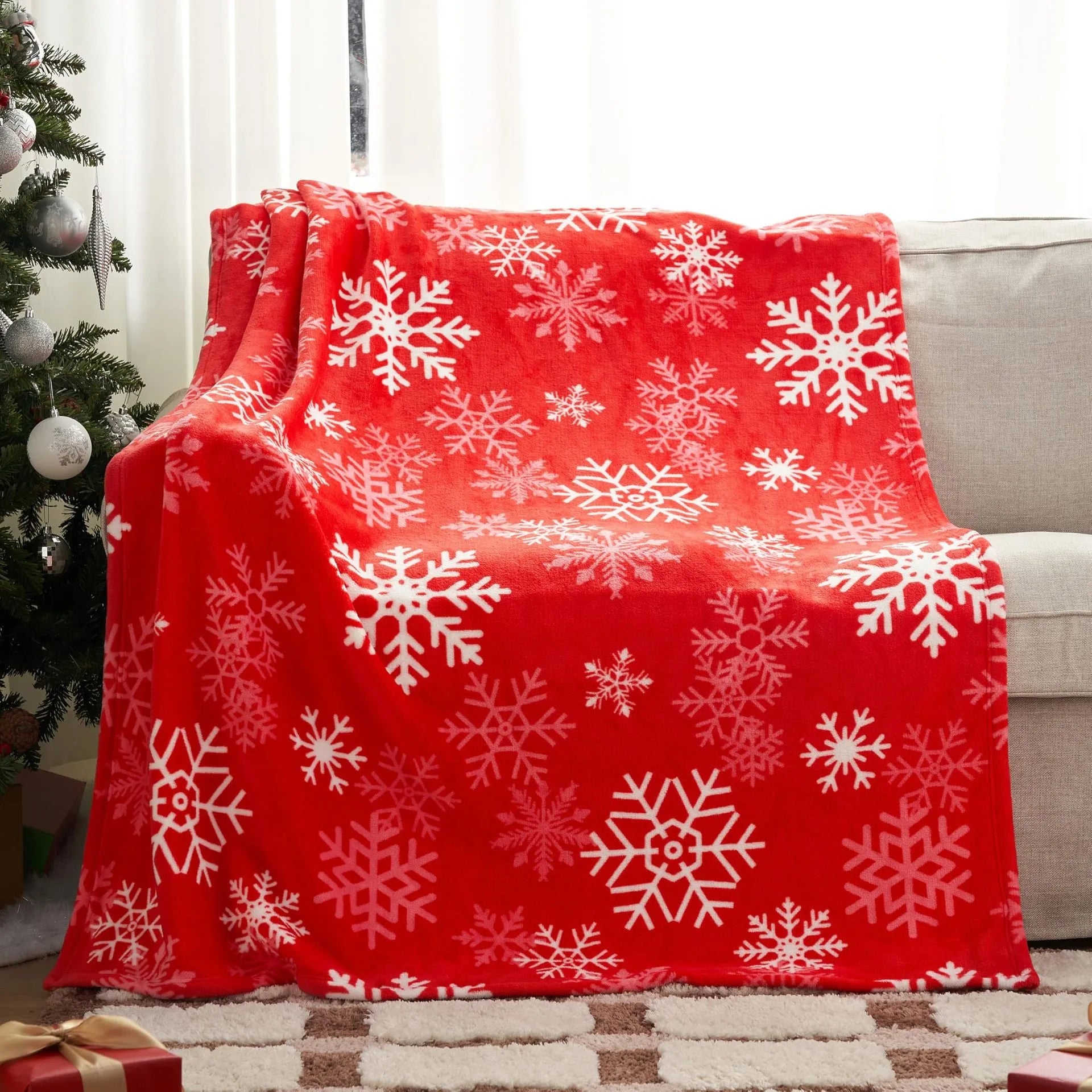 Soft red American style flannel Christmas blanket draped over a sofa