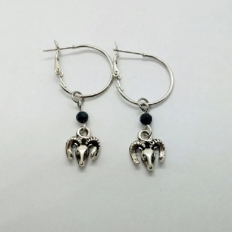 A pair of silver-coloured alloy round ring earrings for women featuring a Tibetan antelope design.