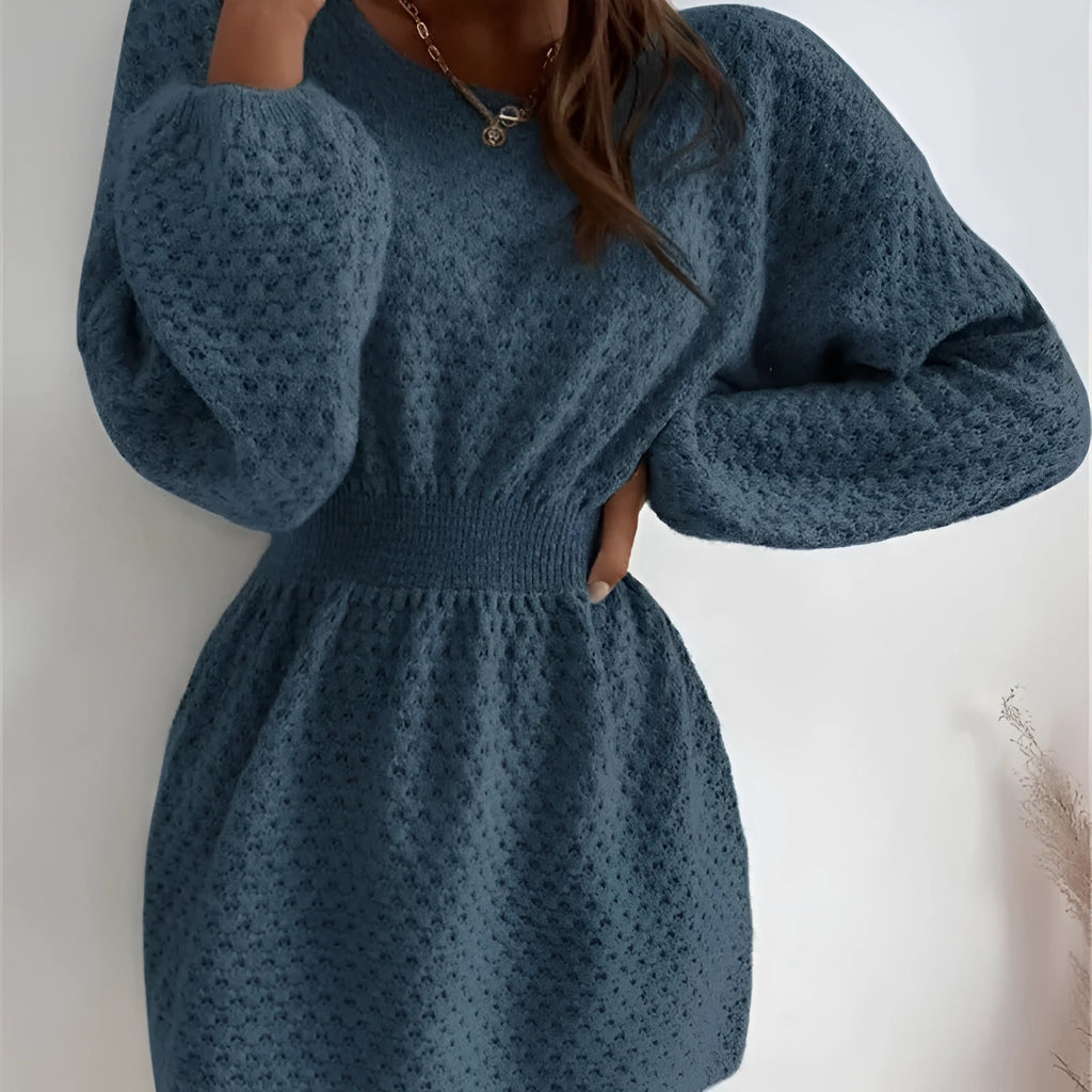 Blue women's knitted dress with hand-crocheted floral details on the front, showing fitted waist and round neck.