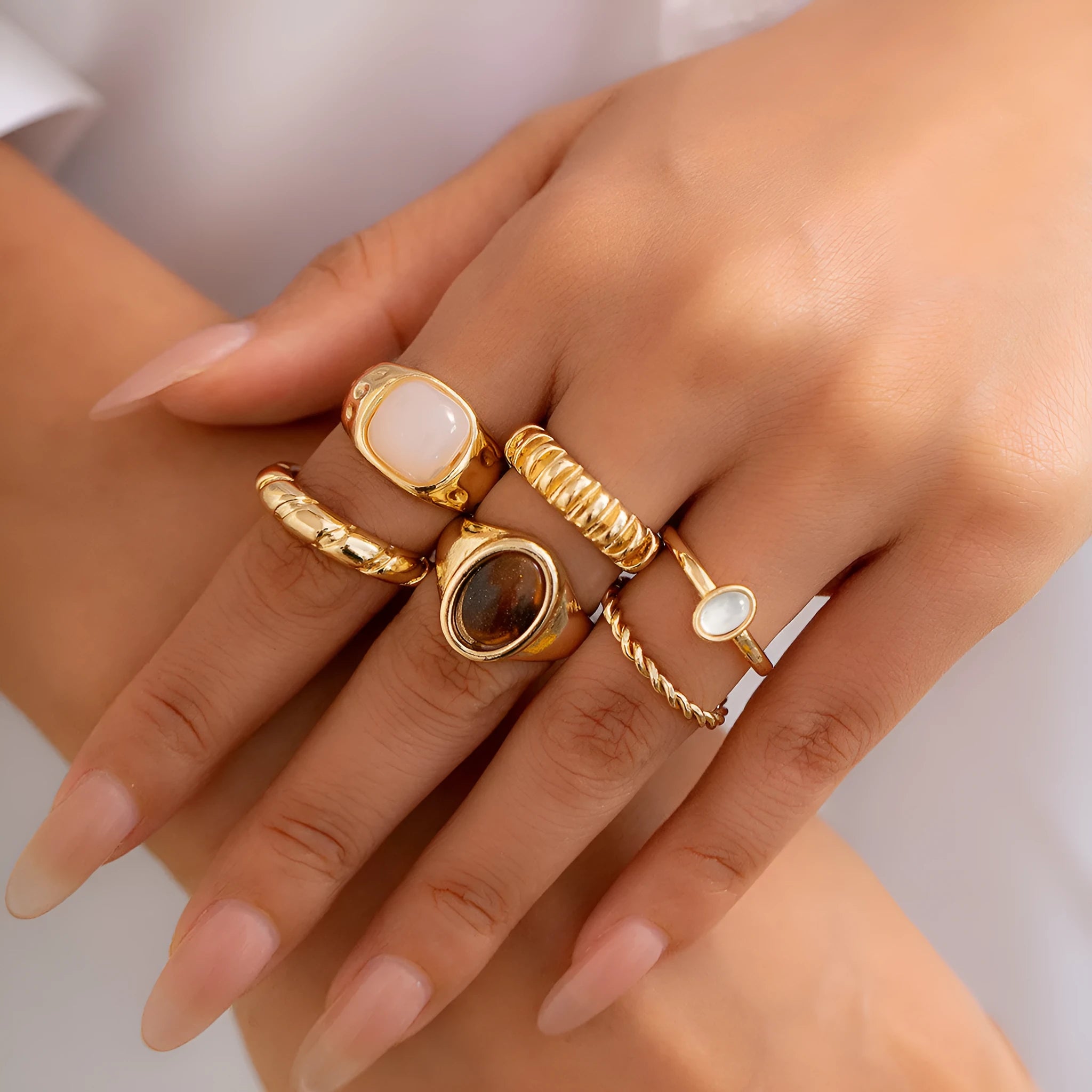 Six light gold geometric alloy rings with electroplated finish displayed together