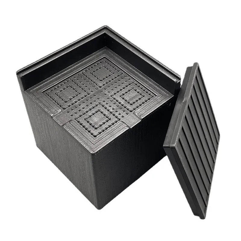 Four black plastic bed foot riser mats for furniture height increasing