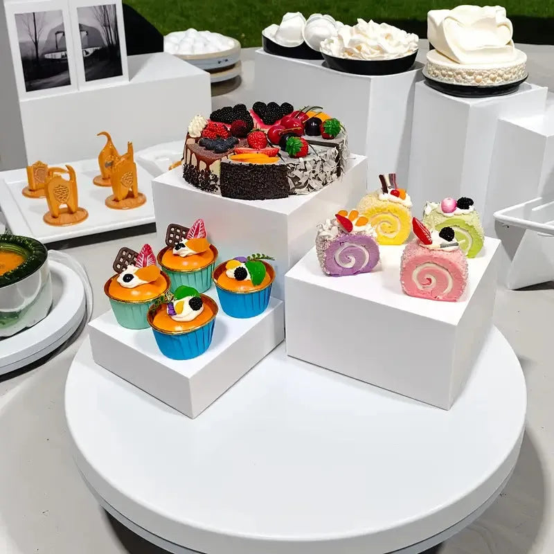 White plastic Suit Cube dessert display stand with six tiers showing cupcakes