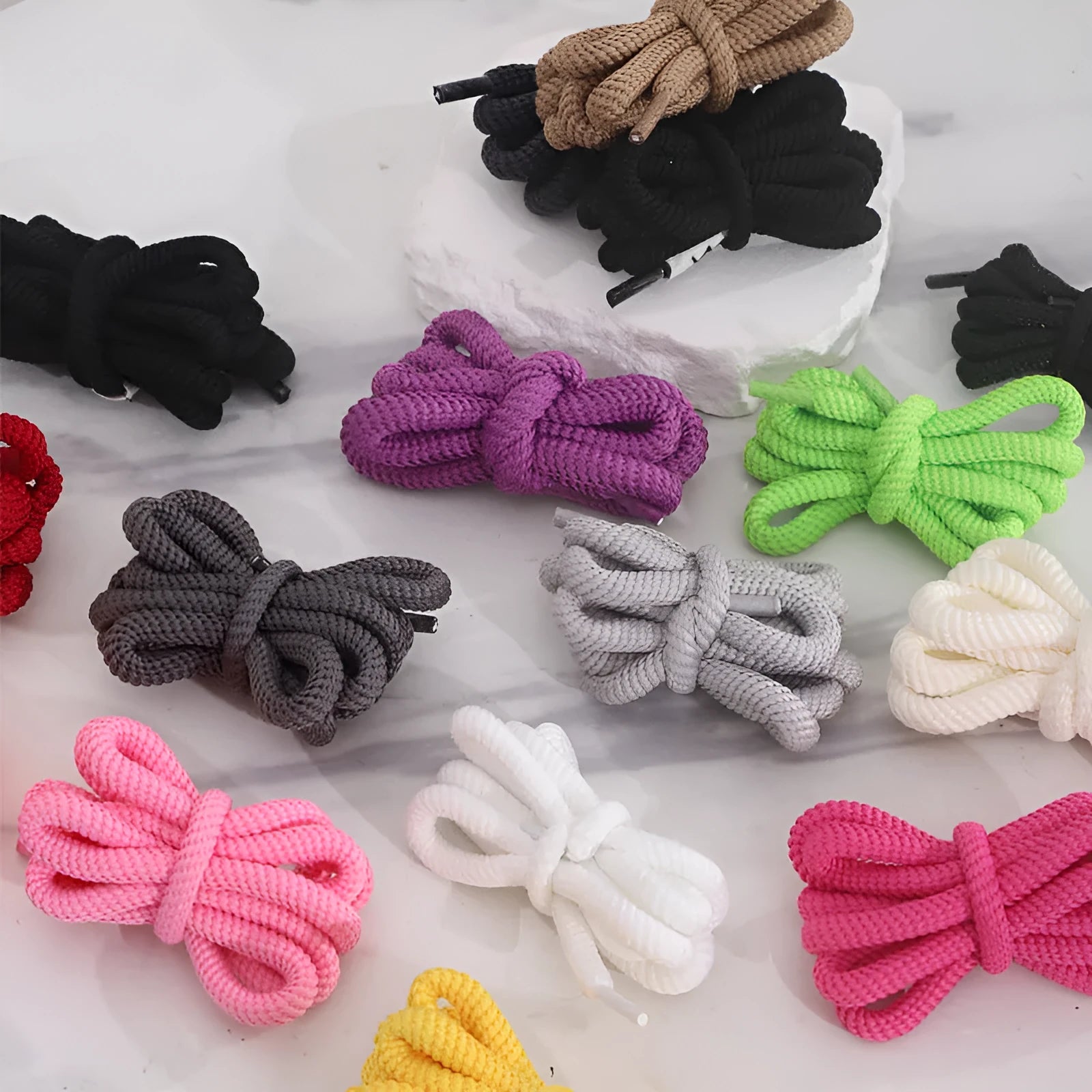 Oval shoelace adapter ropes in multiple colours on a white background, showing the round style.