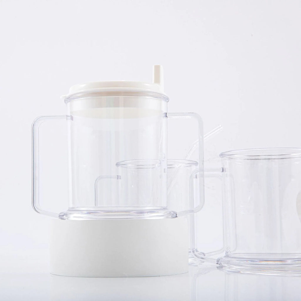 Transparent plastic drinking cup with a lid on a solid background.